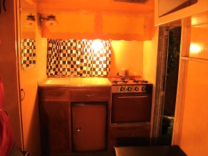 Here's the kitchenette area.  It has the original propane stove and oven as well as the ice box.  You'll also see the original gas lamp in the upper left corner.  I don't think I'll use that since it probably gets pretty warm.