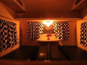 Here's the dinette.  The seats are covered in black vinyl and all the curtains are black and white check.  Not completely hideous, but not my style. 