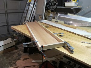 New shelf glued down.  After this dries, I will glue the face onto the base and the frame around it.  Then eventually I'll get to nail it all together.